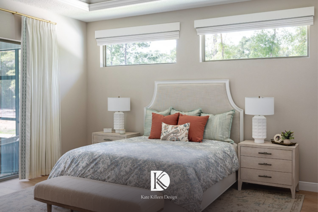 Primary bedroom with an arched upholstered headboard, transom windows, and paired nightstands by Kate Killeen Design