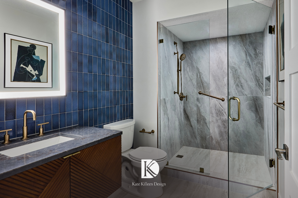 Guest bath with a saturated indigo tile wall, fluted walnut vanity and brushed brass fixtures, by Kate Killeen Design