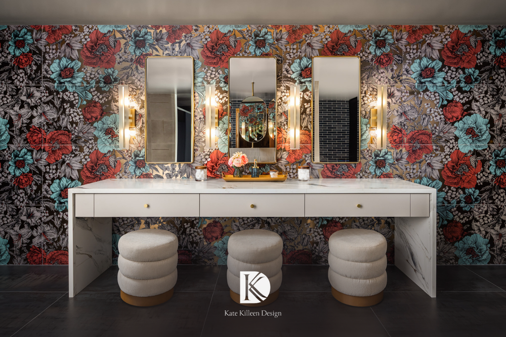 Vanity room with bold floral wallpaper, brass sconces and triple mirrors, by Kate Killeen Design